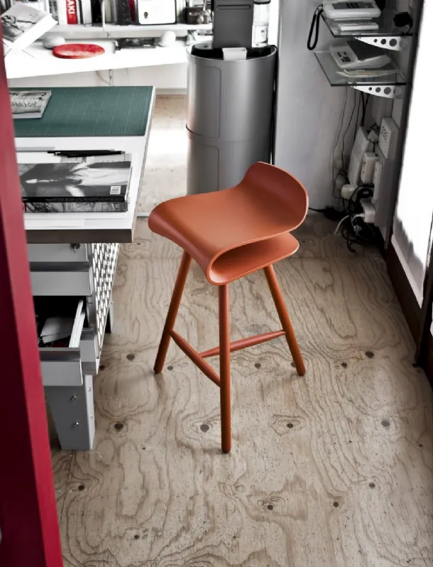 Sgabello dal sedile ergonomico e sinuoso in plastica PBT robusta e flessibile con gambe in legno di frassino BCN Stool di Kristalia